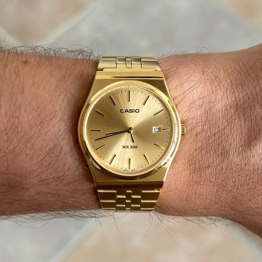 Gold circular Casio watch