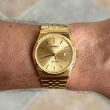 Gold circular Casio watch