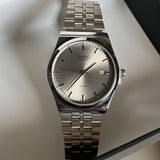 Silver circular Casio watch