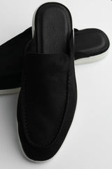 Belugga Dune Mule in black suede, angled view on white sole