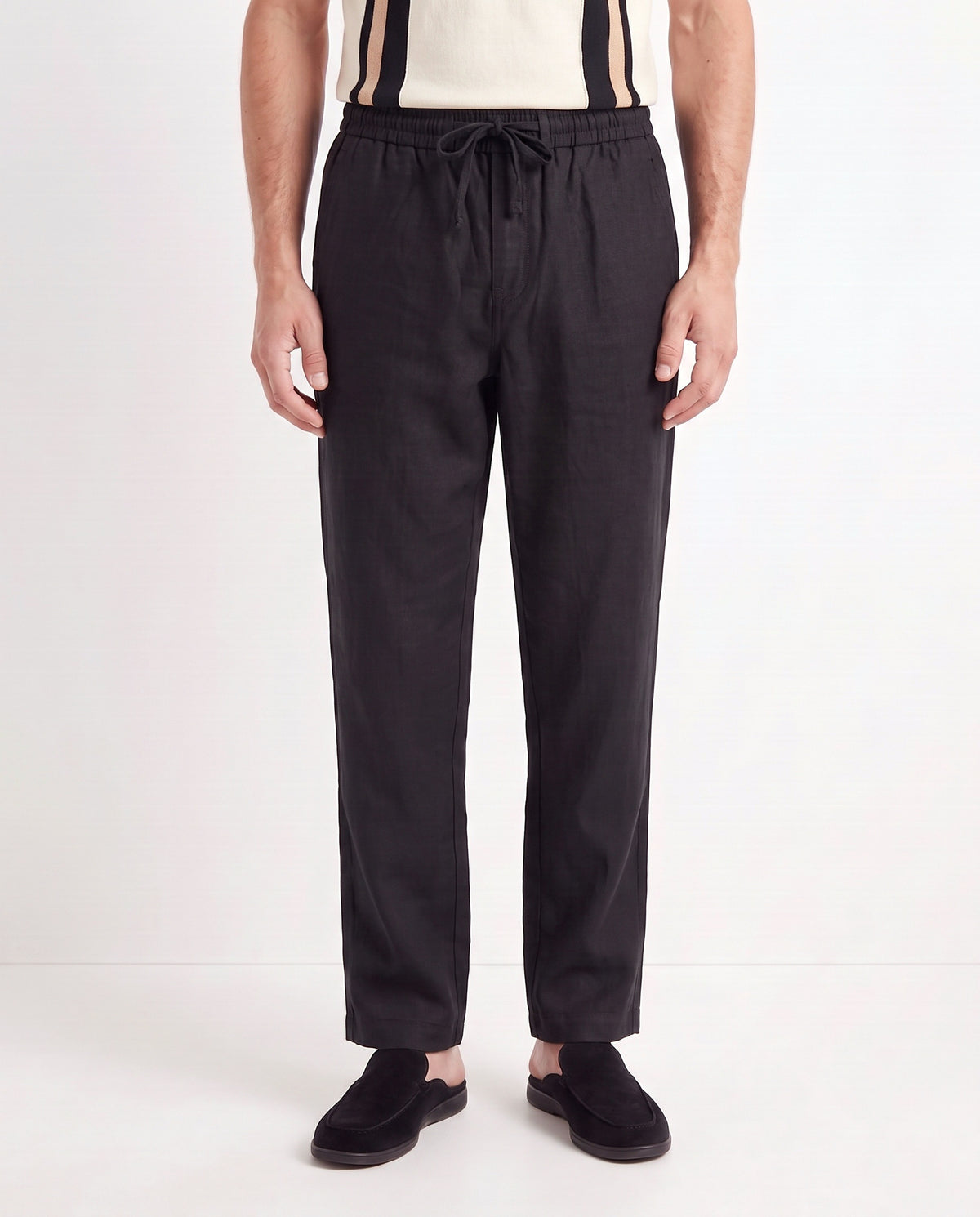 Linen Trouser, Drawstring — Black — close-up on the model, worn with Retro Stripe Knit Polo — Cream and Dune Mule — Black, Black Sole