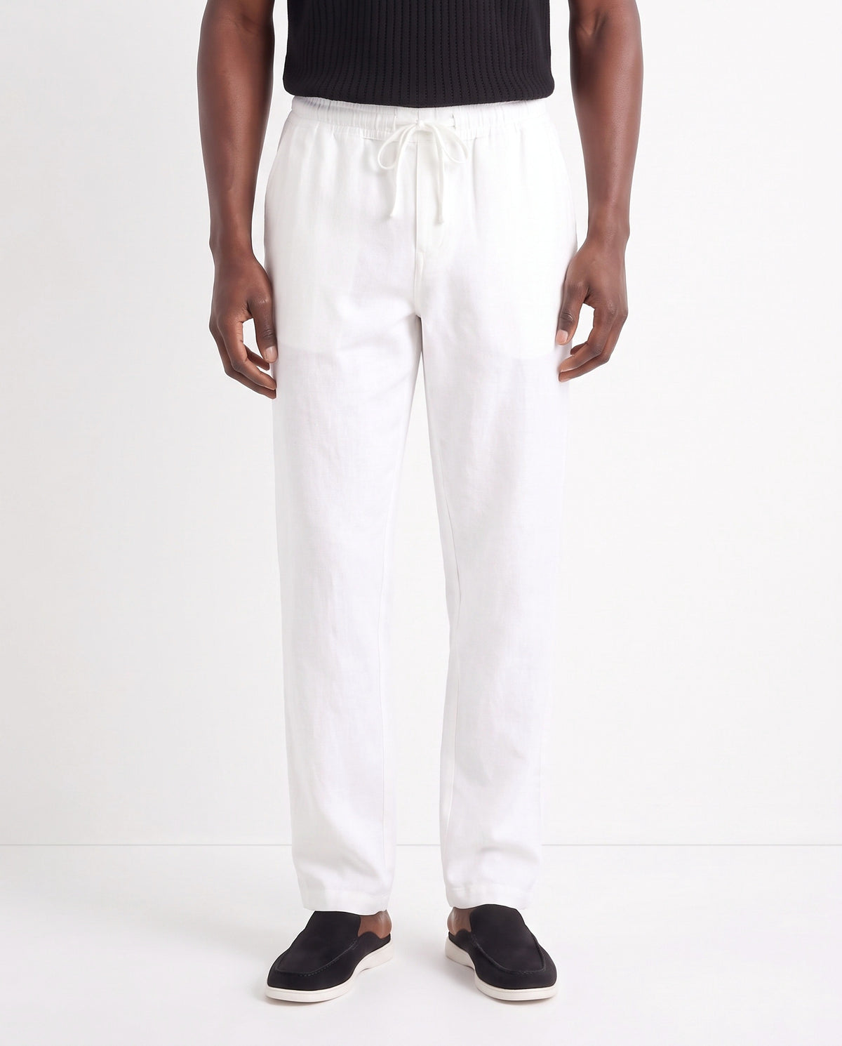 Linen Trouser, Drawstring — White — close-up on the model, worn with Textured Knit Polo — Black and Dune Mule — Black