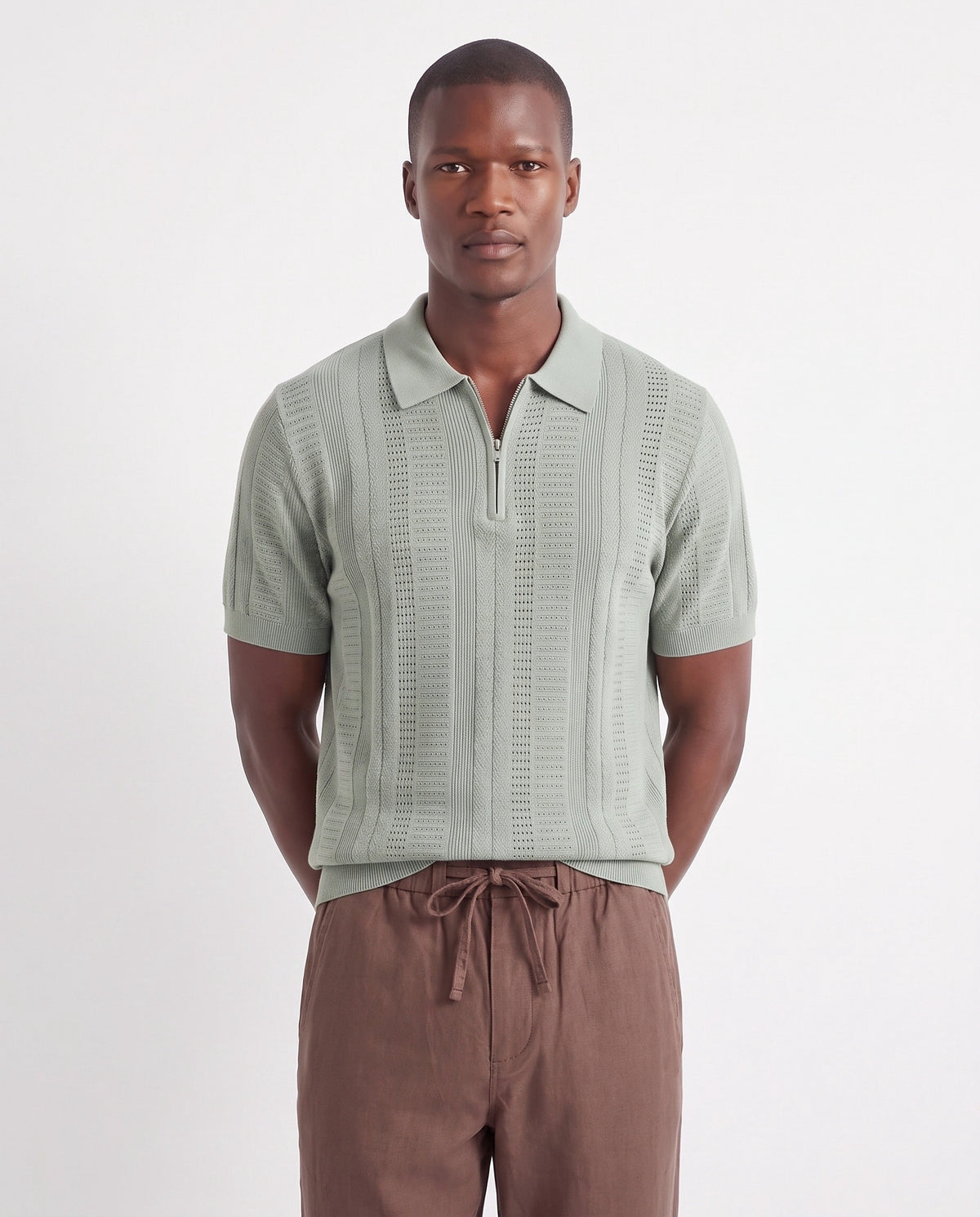 Quarter-Zip Knit Polo — Sage Green — close-up on the model, worn with Linen Trouser, Drawstring — Brown and Dune Mule — Black, Black Sole