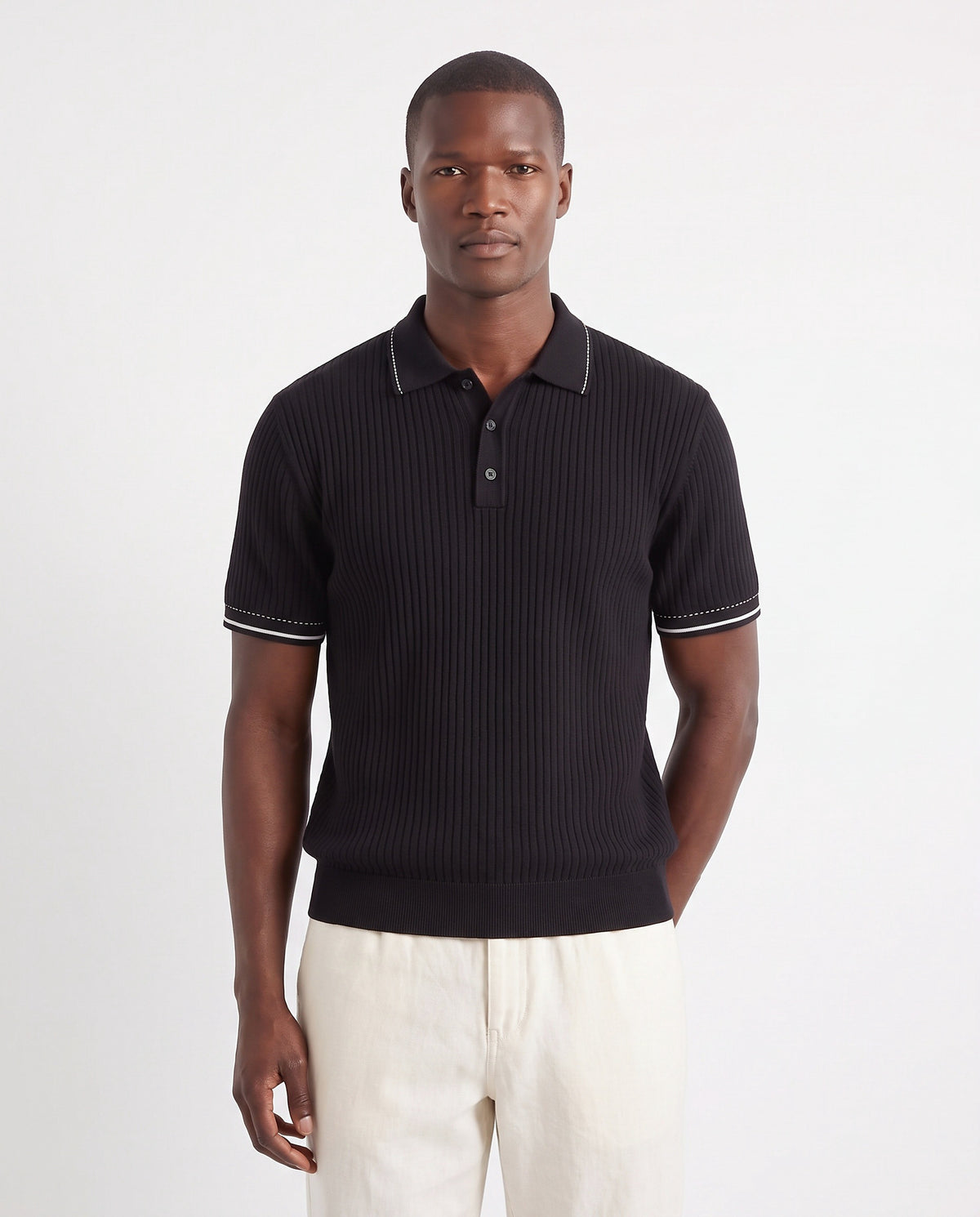 Stitch-Trim Ribbed Polo — Black — close-up on the model, worn with Linen Trouser, Button Waist — Cream and Dune Mule — Cocoa