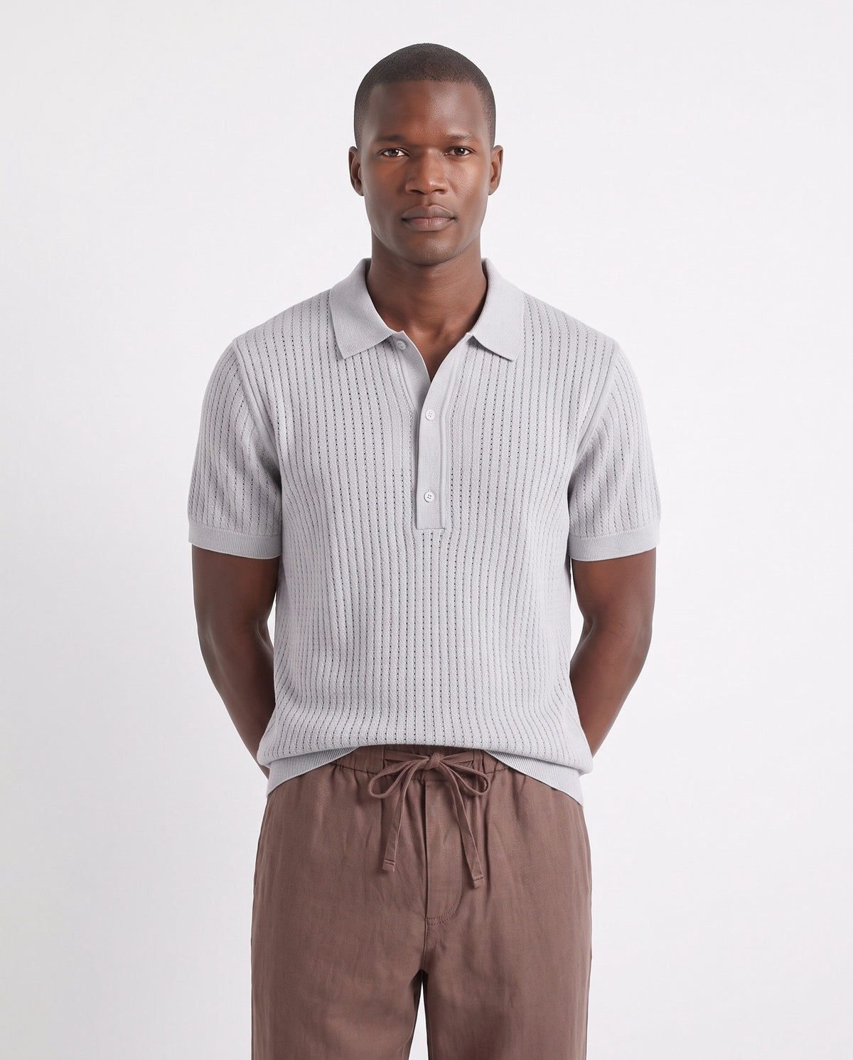 Textured Knit Polo — Light Grey — close-up on the model, worn with Linen Trouser, Drawstring — Brown and Dune Mule — Grey