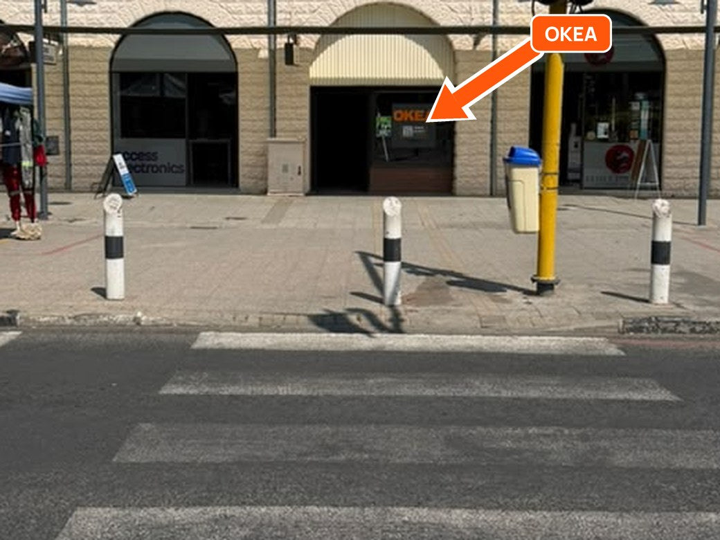The OKEA door with its orange sign, next to Access Electronics